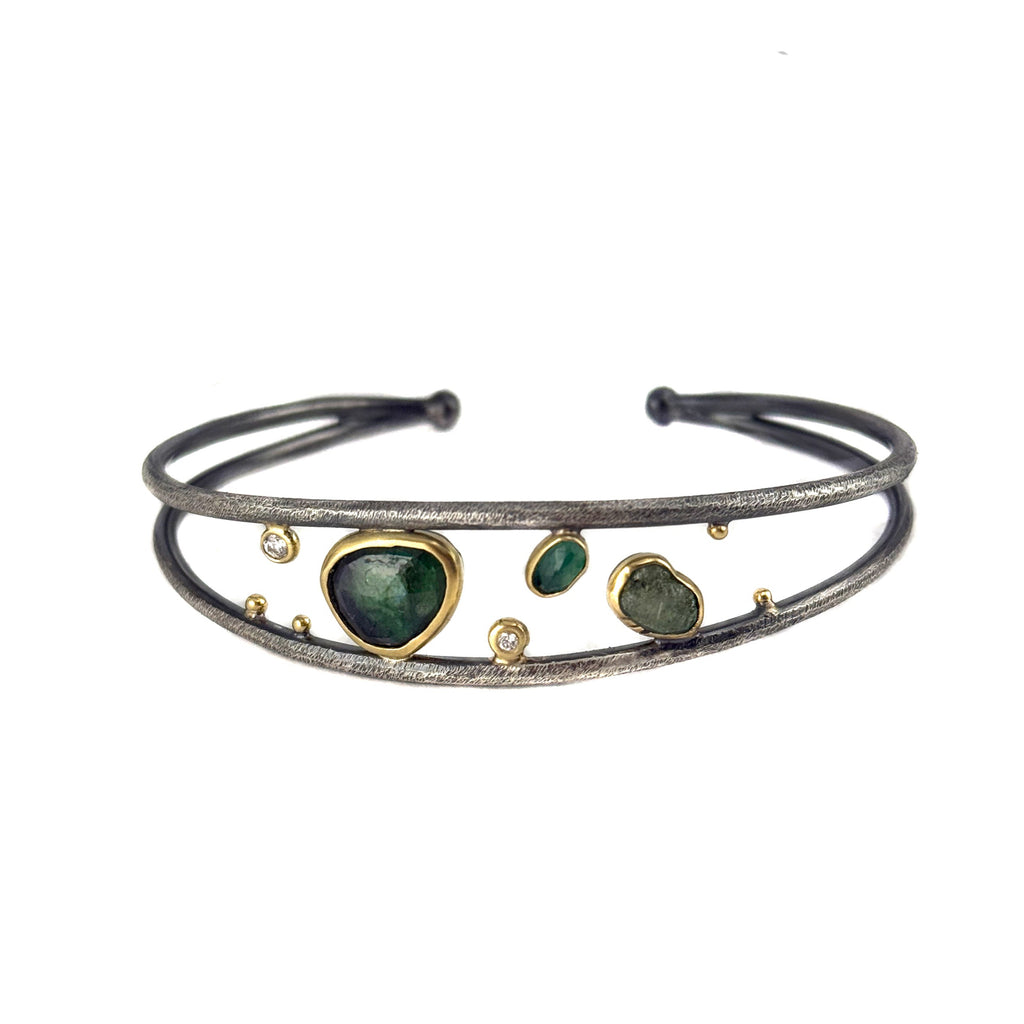 Bracelet with green gemstones on a white background