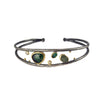 Bracelet with green gemstones on a white background